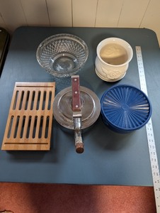 lot 237 image: Kitchenware Collection with Glass Bowl, Ceramic Planter, Blue Storage Container, Bamboo Trivet, and Metal Kettle