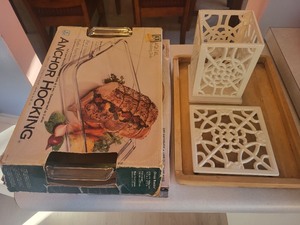 lot 12 image: Anchor Hocking Baking Dish, Gotham Pro Crisper Tray, and Cast Iron Trivet Set with Wooden Tray