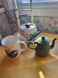 lot 18 image: Minnesota Loon Mug, Green Enamel Teapot, and Floral Stoneware Teapot Set