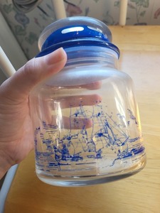 lot 20 image: Nautical Decor Lot with Sailor Dolls, Blue Ship Jar, and Large Seashell