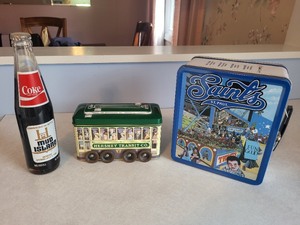 lot 26 image: Lot of 3 Collectibles 1982 Coke Mud Island Bottle, Hershey Transit Co. Tin, St. Paul Saints Lunchbox
