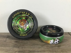lot 256 image: 2 - Collectible Ashtrays  Good Year #1 Eagle D5550 Tire and a Tin Ashtray with Dice on It
