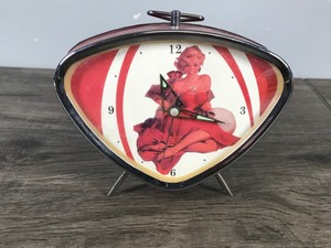 lot 276 image: Vintage Wind Up Clock With Lady Looking Like Marilyn Monroe (unsure if its her)