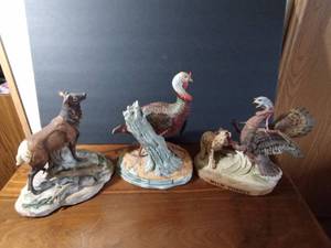 lot 63 image: 1980 W. D. Gaither Turkey Gobbler statue for National wild Turkey Federation and 1983 Austin Nichols Wild turkey and bobcat #2 liquor decanter and 1989 Ski Country Single Elk liquor decanter