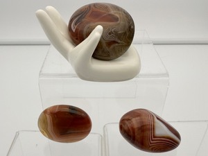 lot 24 image: Sardonyx Palmstone Lot of 3 Hand holder included. Total weight 146 gm.5.3 oz.