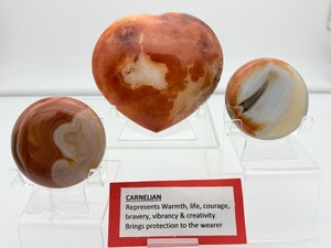lot 84 image: Polychrome Jasper Polished lot of 3 heart 340 gm.12 oz., round palmstone 185 gm.6.5 oz., round palmstone 116 gm.4.1 oz.