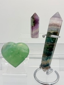 lot 30 image: Fluorite Lot of 3 including a Rainbow Fluorite double terminated wand with stand 189 gm.6.7 oz., a small Rainbow Fluorite tower 45 gm.1.6 oz. and a green fluorite heart 114 gm.4 oz.