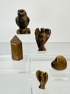 lot 64 image: Tigers eye polished lot of 5 owl 71 gm2.5 oz., angel 25 gm1 oz, small tower 22 gm.8 oz. , small heart 17 gm.6 oz. and small angel 9 gm..3 oz.  Total lot weight 147 gm5.2 oz.
