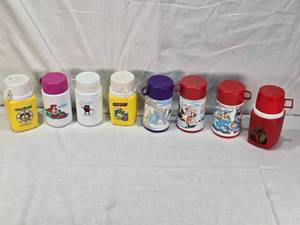 lot 9 image: Character-Themed Lunch Box Thermos including Garfield, The Little Mermaid, The California Raisins, Smurfs, and Coca-Cola