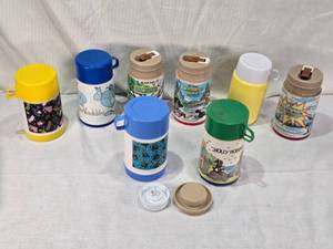 lot 27 image: Lot of Vintage Lunch Box Thermo Bottles Featuring Various Designs such as Aladdin and Sesame Street