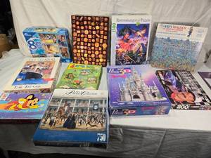 lot 56 image: Lot of Jigsaw Puzzles including Disney 8 Puzzle Pack, Ravensburger 1500 Piece Puzzle, and More - Uncounted