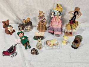 lot 60 image: Figurines and Collectibles Including Peter Pan Doll, Cultural Dolls, Woven Bunny, Ceramic Stagecoach Shaker, and Animal Figures