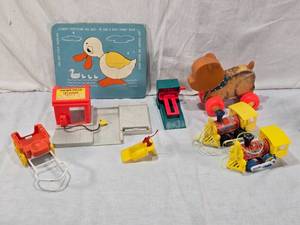 lot 86 image: Fisher-Price Toys including Lumber Yard and Toot-Toot Trains, Pull Toy Bear, and Ugly Duckling Puzzle with Glued In Pieces