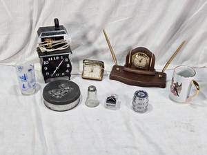 lot 106 image: Desk Clock with Pens, Elgin Folding Alarm Clock, Texas Souvenir Glass, Spartus Corp Stove Clock and Miscellaneous Items
