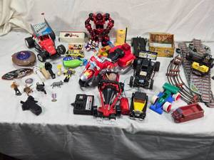 lot 115 image: Vintage and Modern Toys including Tin Train Set, Toy Cars, and Action Figures