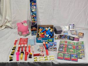 lot 130 image: Lot of Vintage Toys and Collectibles including Little Tikes Piggy Bank, Toy Story Kite, and Trading Cards Like PukeMon