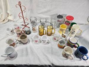 lot 167 image: Assorted mugs and glasses including Kimball MN glass mug, Lutsen Glass, Oakley National Bank, Budweiser mugs, and various commemorative mugs
