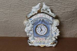 lot 6 image: Porcelain Mantel Clock with Cherubs and Doves Accents