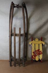 lot 36 image: Antique Wooden Sled with Rope and Decorative Miniature Merry Christmas Sled