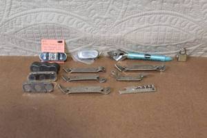 lot 100 image: Vintage Beer Openers, Folding Stamps, and Collectible Tool Lot