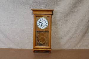 lot 162 image: Wall Mount Pendulum Clock with Oak Finish and Roman Numeral Dial
