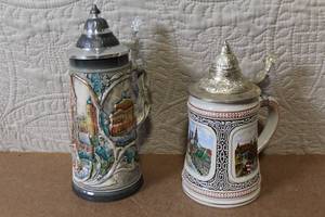 lot 191 image: Pair of German Beer Steins with Pewter Lids and City Scenes