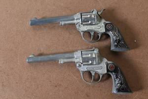 lot 199 image: Pair of Vintage Sure Shot Toy Cap Guns with Western Design Grips