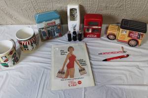 lot 256 image: Coca-Cola Collectibles Lot with Vintage Tins, Mugs, Banks, and Memorabilia
