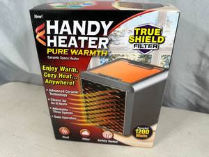 lot 249 image: New Handy Heater Pure Warmth Ceramic Space Heater with LED Lights