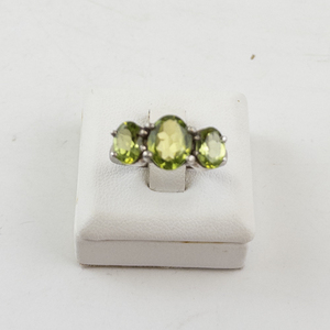 lot 30 image: Sterling Silver Three Stone Peridot Ring Size 6.