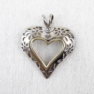 lot 106 image: Sterling Silver and 10K Gold Heart Pendant 2.29g