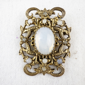 lot 148 image: Vintage Ornate Brooch with White Opalescent Center Stone.