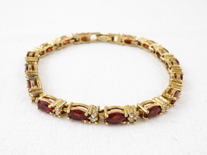 lot 166 image: AVON Gold Tone Tennis Bracelet with Red and Clear Stones