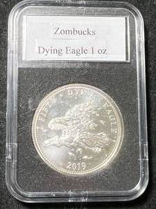 lot 10 image: 1 TROY OZ .999 FINE SILVER ZOMBUCKS DYING EAGLE ROUND SLABBED