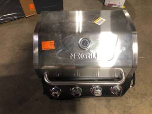lot 25 image: Nexgrill 4-Burner Propane Gas Grill in Black with Stainless Steel Main Lid Missing Parts Customer Returns See Pictures