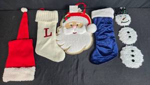 lot 43 image: Assorted Christmas Decor Lot Stockings, Santa Hat, Santa and Snowman Decorations