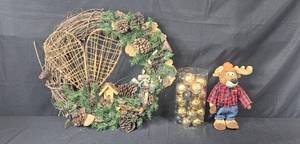 lot 59 image: Rustic Wreath with Pinecones, Holiday Ornament Set, and Cabelas Moose Plush