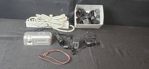 lot 119 image: Assorted Electronics and Accessories Including Brookstone Alarm Clock, Power Supplies, Cables, and Power Strip
