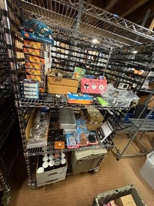 lot 65 image: Key chains, Flashlights, rubber bands,  aluminum wallets, poker set in case, shot glasses