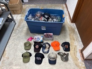 lot 112 image: Tub (included) of hats, vinyl decals, lip balm holders