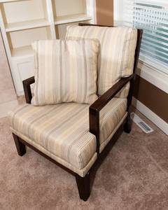 lot 16 image: Ashley Furniture Chair with Matching Throw Pillow