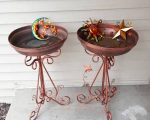 lot 272 image: Two Copper-Colored Bird Baths & Three Colorful Metal Wall Hangings