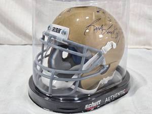 lot 13 image: Rudy Ruettiger Auto with Movie Quote Schutt Authentic Mini Notre Dame Fighting Irish Helmet