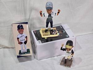 lot 21 image: Lot of 3 Russell Wilson Bobblehead Figures including a Super Bowl Win Figure, Grizzlies and Dust Devils