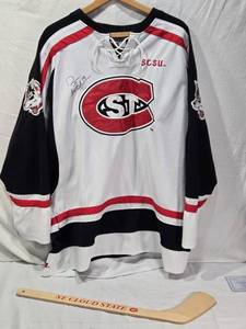 lot 40 image: Drew LeBlanc Signed St. Cloud State University Hockey Jersey Size Large with Mini Hockey Stick