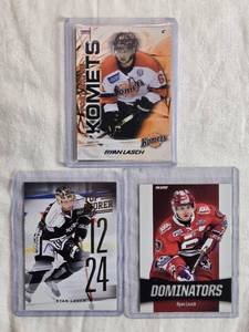 lot 214 image: Lot of 3 Ryan Lasch Hockey Cards featuring Komets, Dominators, and Top Scorer cards.