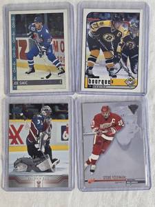 lot 306 image: Lot of 4 Hockey Cards Featuring Ray Bourque, Steve Yzerman, Joe Sakic, and Patrick Roy.