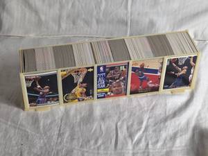lot 319 image: 13 12 Plastic Case Basketball Cards with Various Years and Brands Such as Upper Deck 89-90, Fleer 91, Topps Total and More - Uncounted