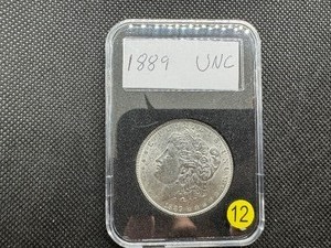 lot 12 image: 1889 Morgan Silver Dollar Marked UNC When Purchased