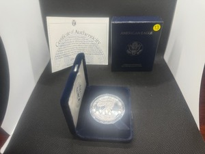 lot 13 image: Better Date Beautiful 1994 Proof American Silver Eagle, Original Mint Case wCOA - PCGS Price Guide for a PF-69 is $130, PF-70 is $900